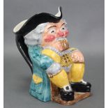 A Clarice Cliff Newport pottery toby jug, the seated Toby with rouge cheeks & nose, clutching a