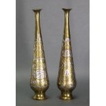A pair of Eastern brass slender ovoid vases with embossed stylised decoration & Arabic script in