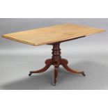 A George IV mahogany tilt-top breakfast table, the rectangular top with moulded edge, on vase-turned
