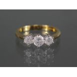 An 18ct. gold ring set three graduated diamonds, the centre stone approx. 0.5 carat, the two smaller