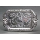 A late Victorian silver rectangular tray, with embossed decoration of cherubs & husk-swags, the