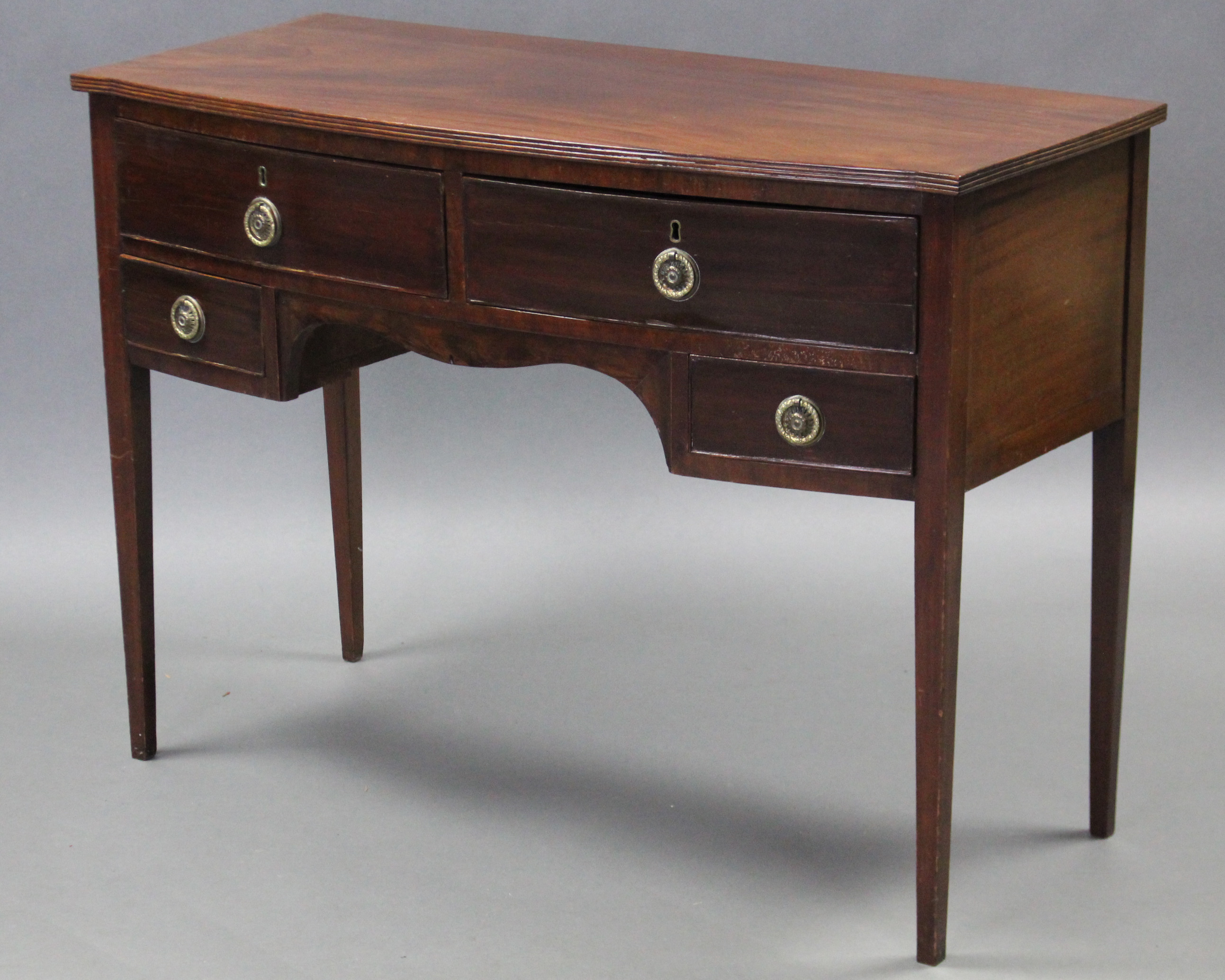 A Georgian mahogany bow-front sideboard fitted two frieze drawers above a shaped apron, a smaller