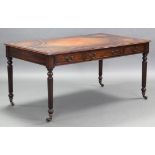 A Regency-style partner’s writing table with rectangular gilt-tooled tan leather top, fitted three