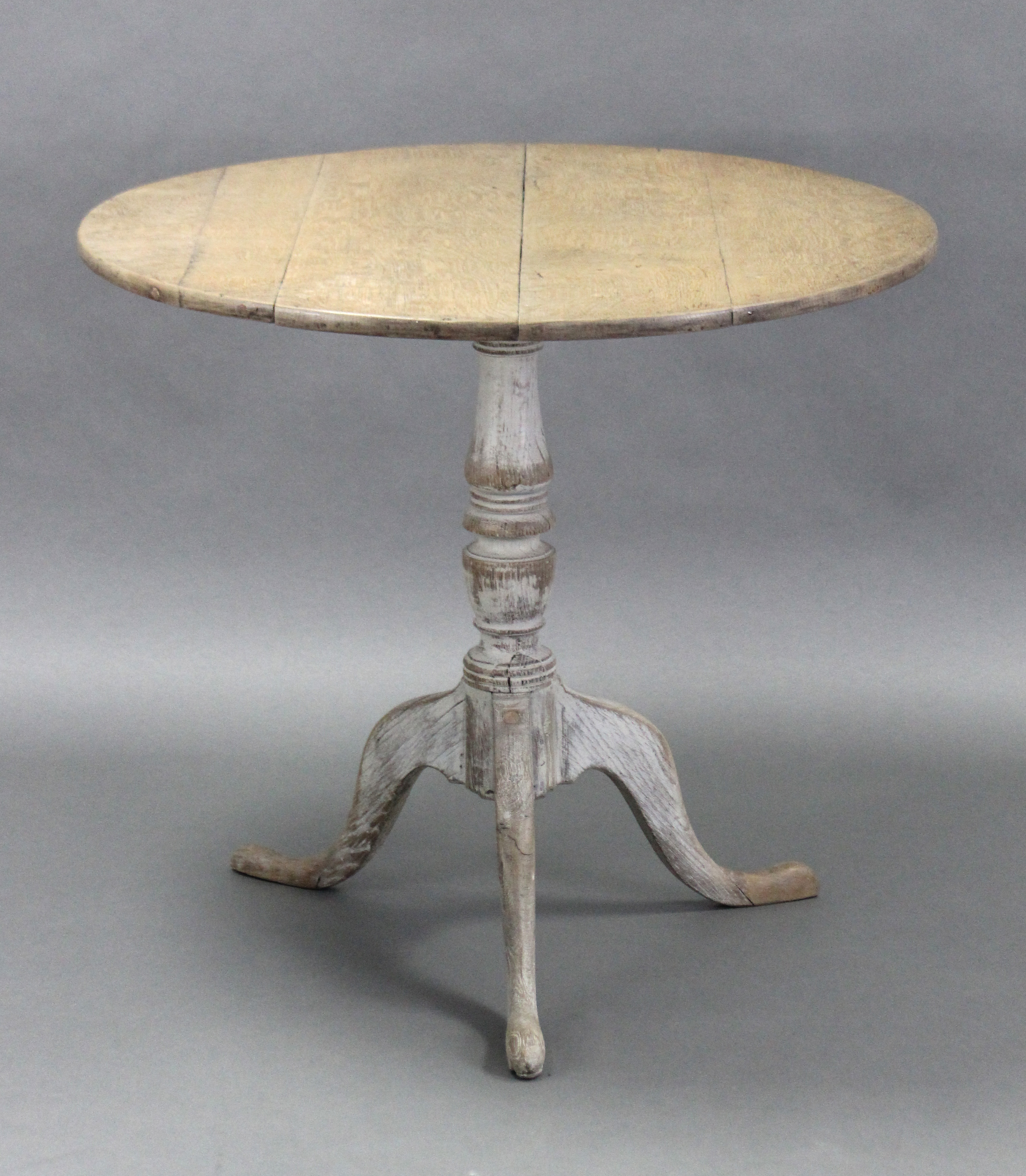 A limed oak tripod table with plain circular top on vase-turned centre column & cabriole legs with