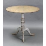 A limed oak tripod table with plain circular top on vase-turned centre column & cabriole legs with