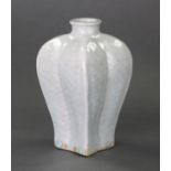 An unusual oriental porcelain baluster vase moulded in low relief as four conjoined fish, with short
