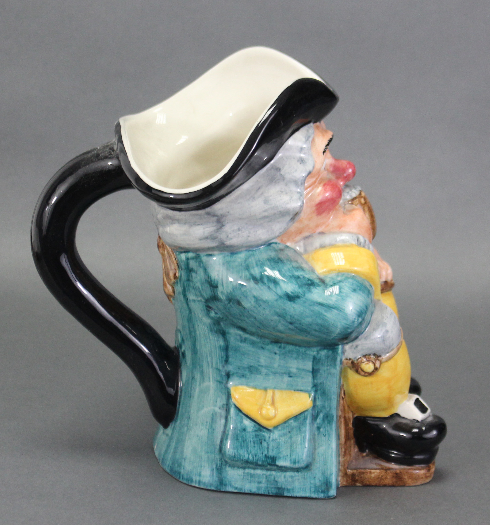 A Clarice Cliff Newport pottery toby jug, the seated Toby with rouge cheeks & nose, clutching a - Image 2 of 3