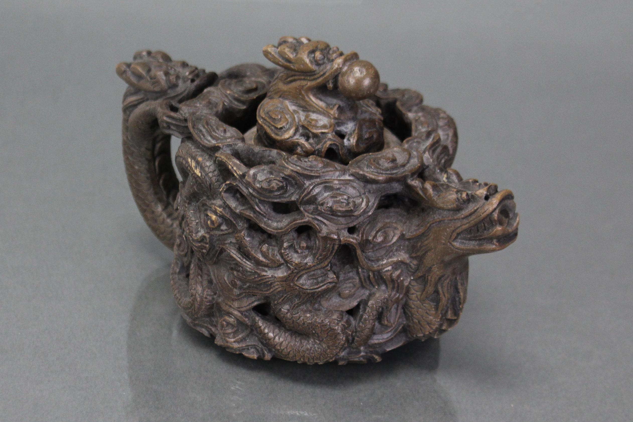 A Chinese soapstone reticulated teapot, deeply carved & pierced with encircling dragons, with - Image 2 of 4