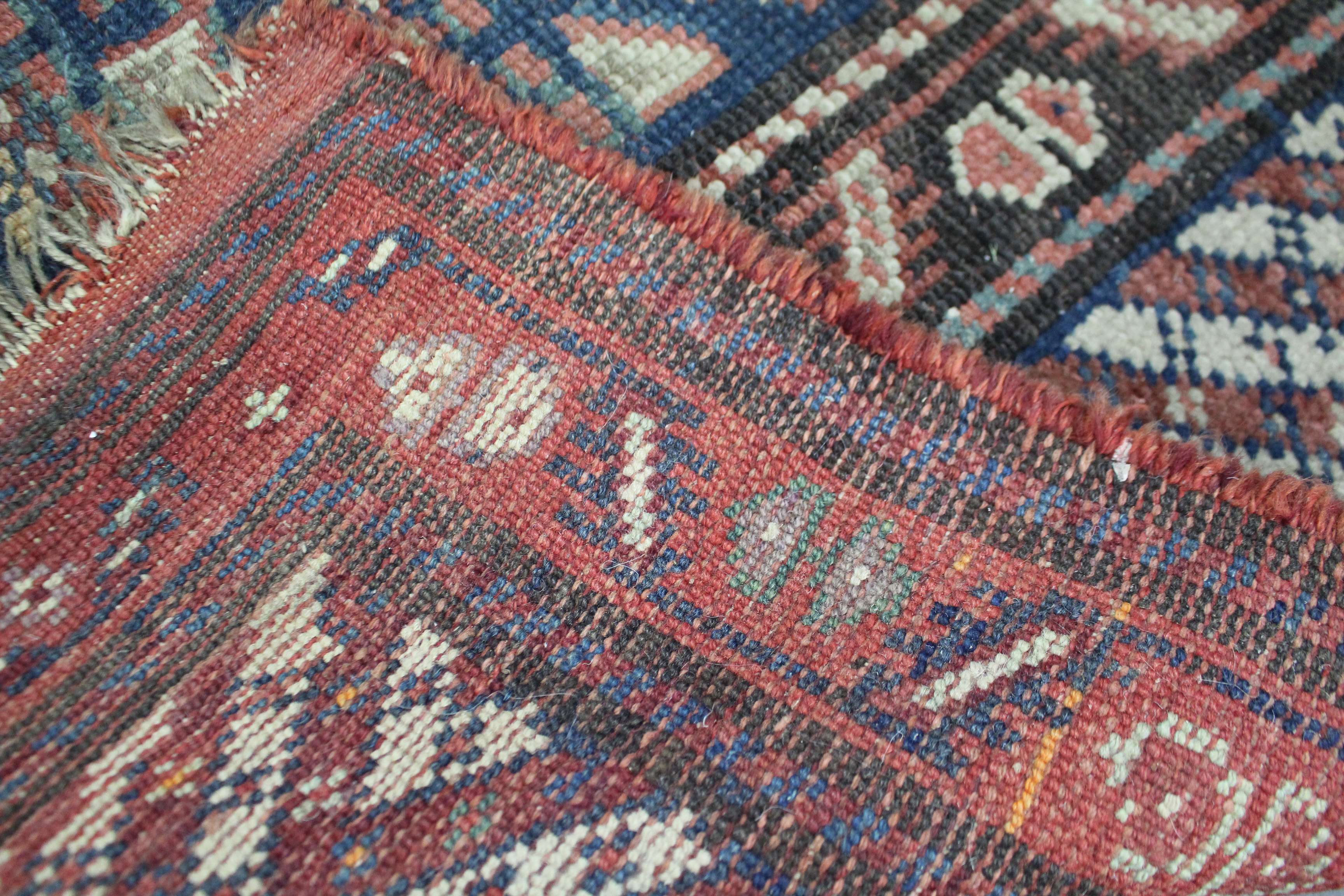 A Persian corridor runner of blue, crimson, & ivory ground, with central panel of guhls within - Image 2 of 2