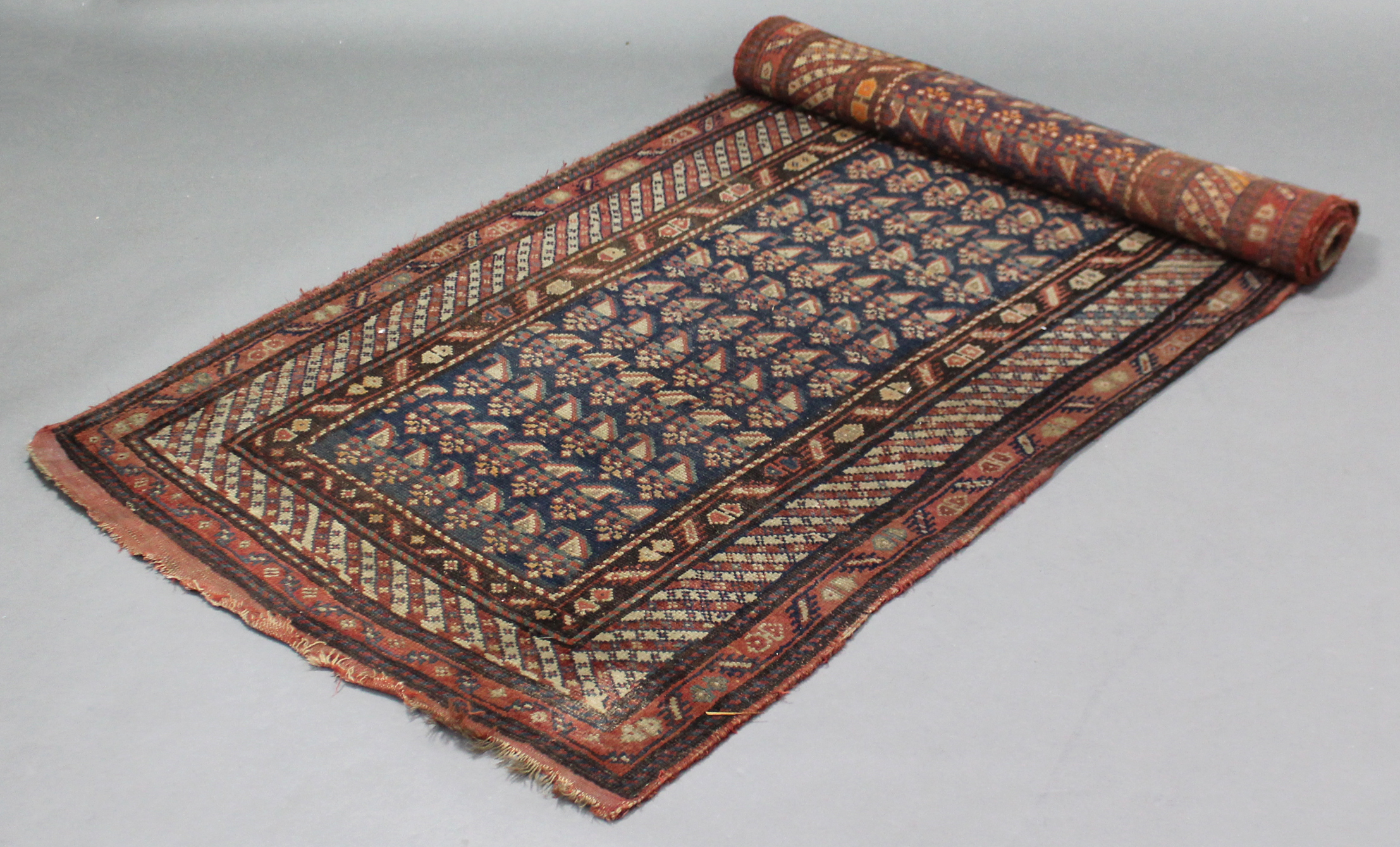 A Persian corridor runner of blue, crimson, & ivory ground, with central panel of guhls within