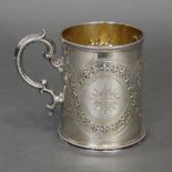A Victorian silver cylindrical mug embossed with interwoven bands of flower-heads, with beaded