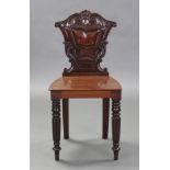 A William IV mahogany hall chair with carved back, & on turned front legs.