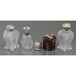 A pair of Edwardian cut glass water bottles with silver lids, London 1903 (w.a.f.); a similar