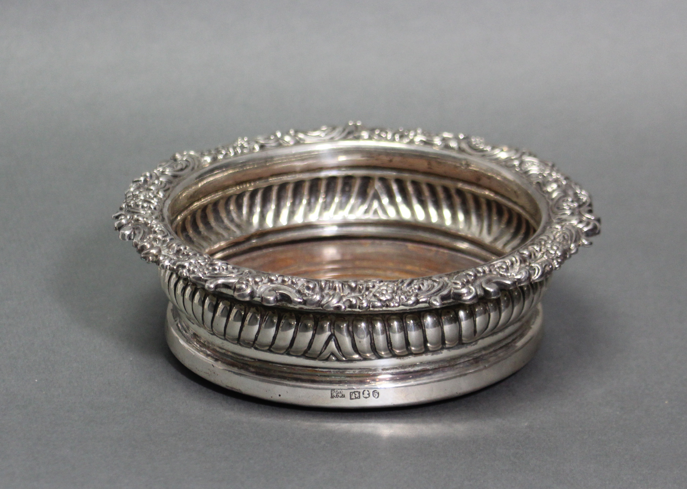 A George III silver wine coaster, with cast foliate scroll border & gadrooned sides, inset turned - Image 2 of 2