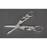 A pair of modern silver grape scissors, the cast stems with male & female figures standing beneath