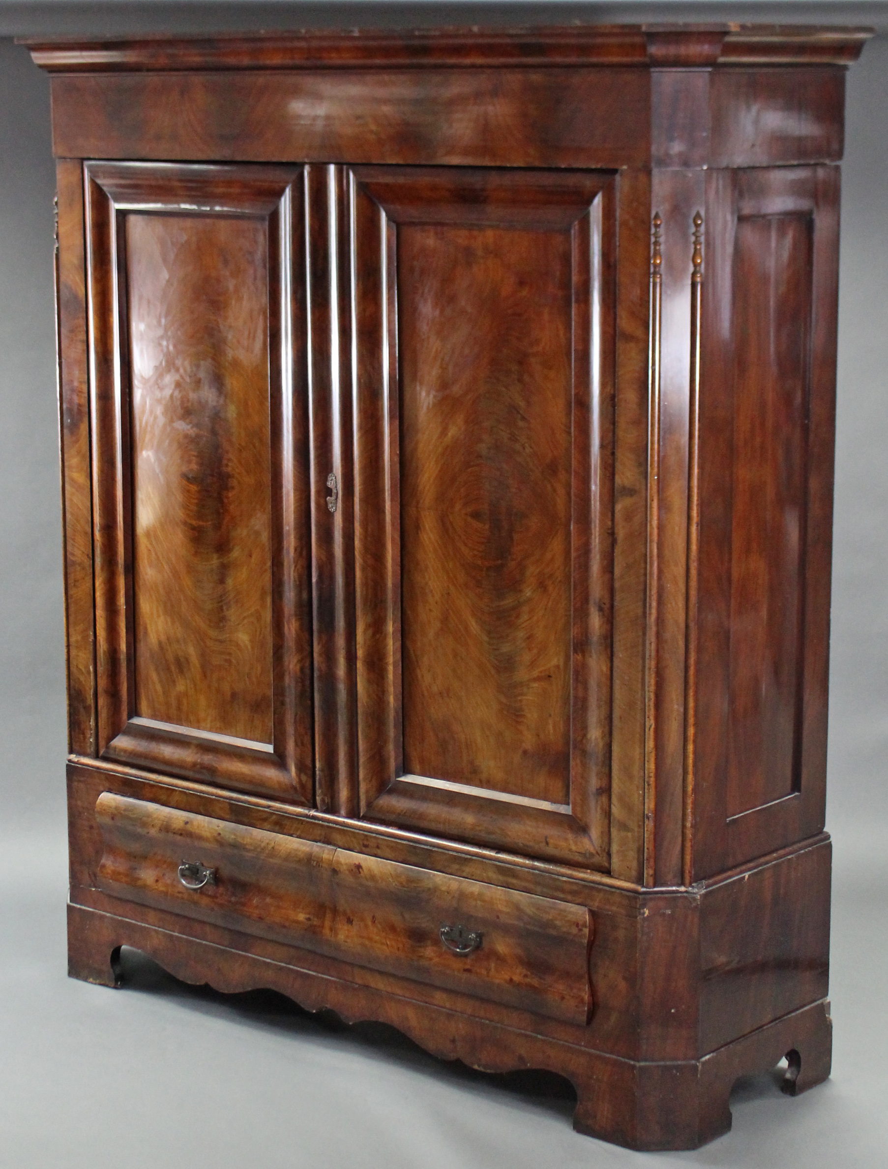A 19th century CONTINENTAL FIGURED MAHOGANY WARDROBE, the upper part with cavetto cornice & enclosed