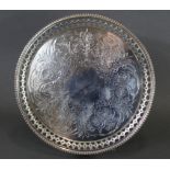 A Victorian silver circular tray with engraved floral decoration, the pierced border with