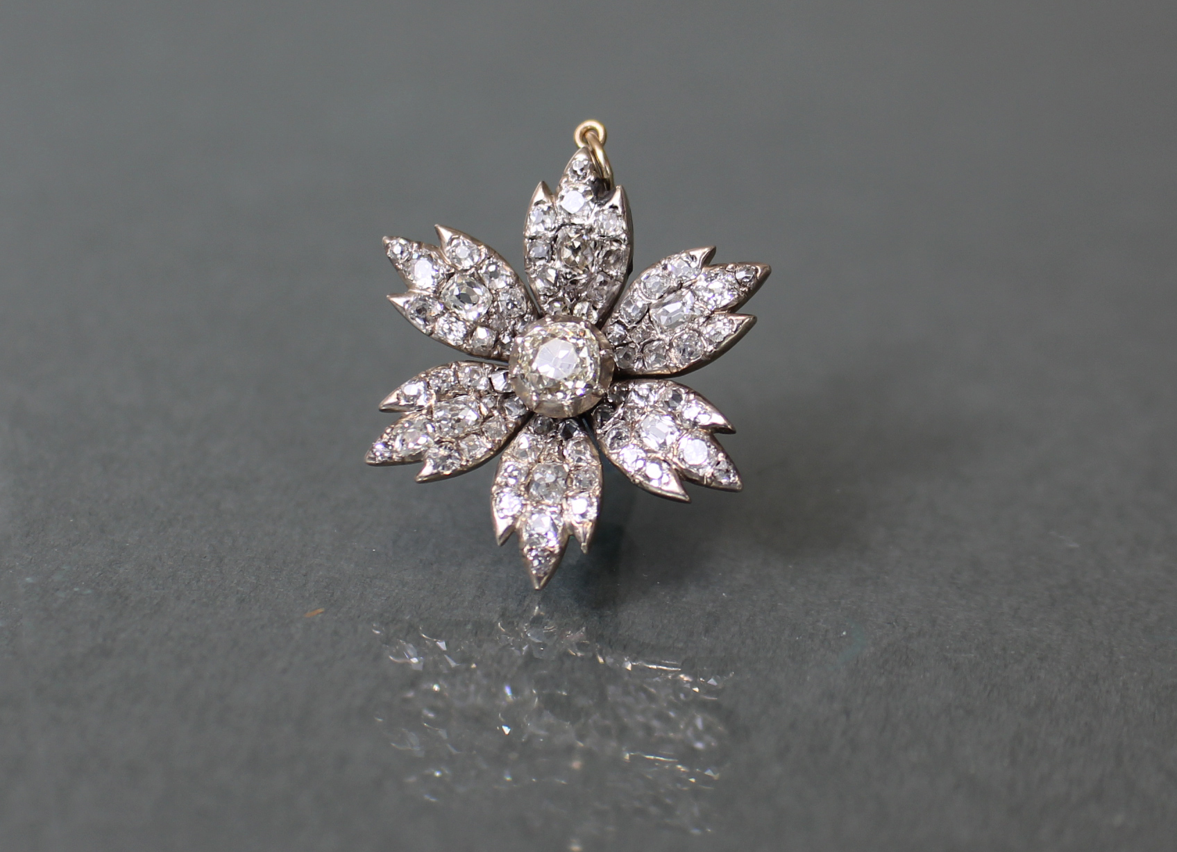 A DIAMOND FLOWER-HEAD PENDANT, the centre stone approximately 0.5 carat, surrounded by six petals - Image 2 of 5