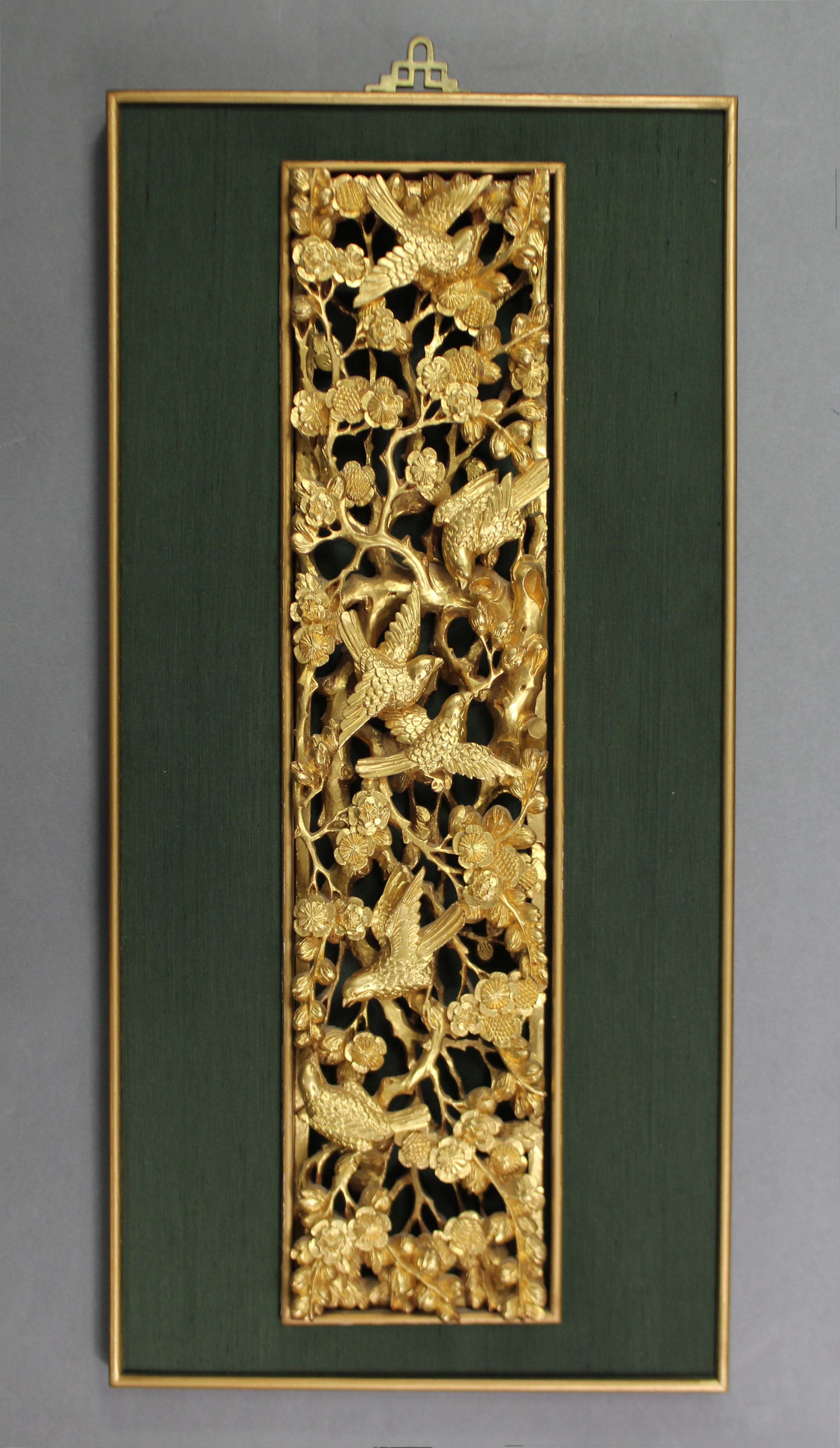 A Chinese carved & pierced giltwood panel depicting birds amongst prunus blossom, mounted for wall