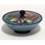 A Moorcroft squat round covered bowl with flowers to the lid; 6¼” diam.