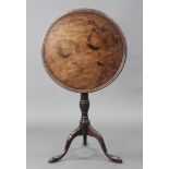 A late 18th century mahogany tripod table, the circular tilt-top with raised moulded edge on vase-