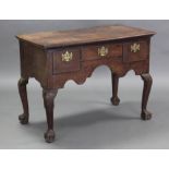 An 18th century oak side table with rectangular top, fitted three frieze drawers with brass swan-