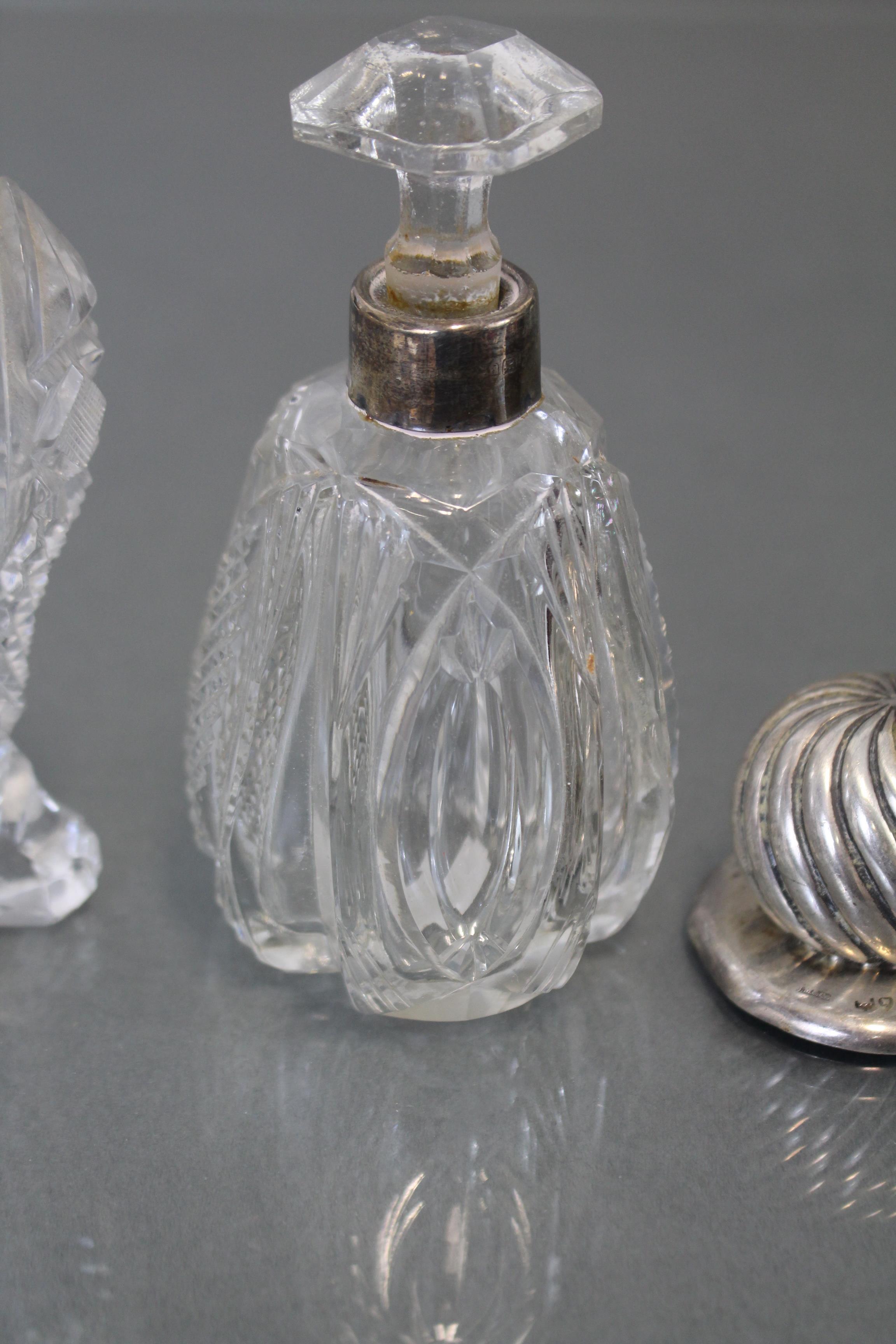 A pair of Edwardian cut glass water bottles with silver lids, London 1903 (w.a.f.); a similar - Image 4 of 5