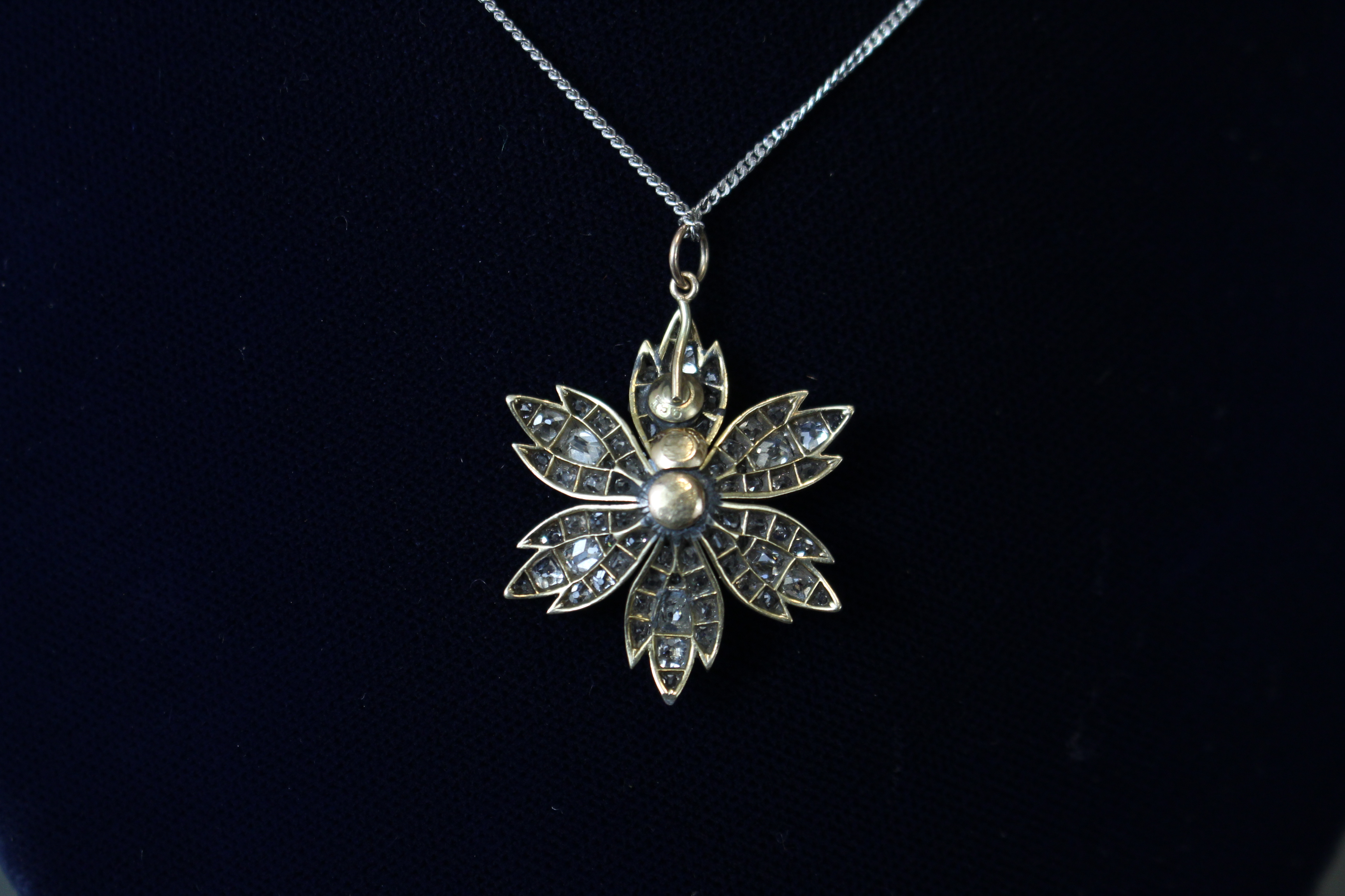 A DIAMOND FLOWER-HEAD PENDANT, the centre stone approximately 0.5 carat, surrounded by six petals - Image 4 of 5