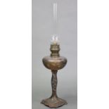 A French Art Nouveau oil lamp, the glass reservoir with etched & coloured floral decoration, on