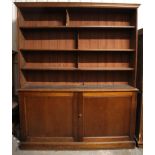 AN EARLY VICTORIAN MAHOGANY BOOKCASE, with moulded cornice above four graduated shelves enclosed