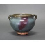 A Chinese Junyao-type pottery jarlet of compressed round form with small ring side-handles, a purple
