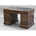 A late 19th century oak pedestal desk with moulded edge to the rectangular top, inset leather