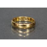 A 22ct. gold wedding band; size: M. (4.6gm).