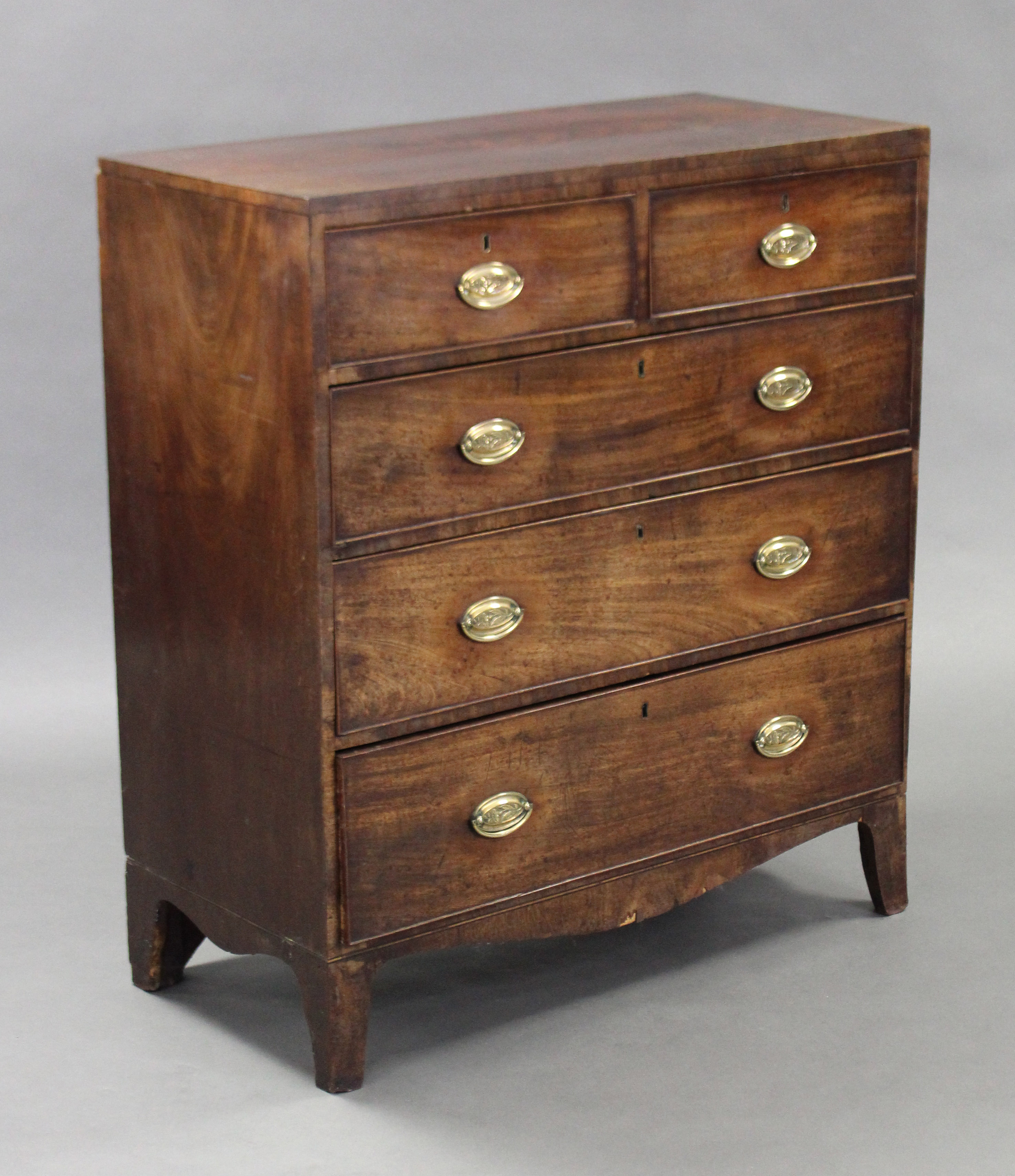 A Georgian inlaid mahogany chest, fitted two short & three long graduated drawers with brass oval