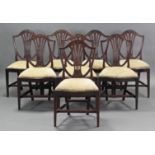 A set of eight 19th century Hepplewhite-style dining chairs, the shield-shaped backs with pierced