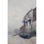 ERNEST DADE (1868-1936). Beached fishing vessels beside a row of buildings. Signed & dated ’86 lower
