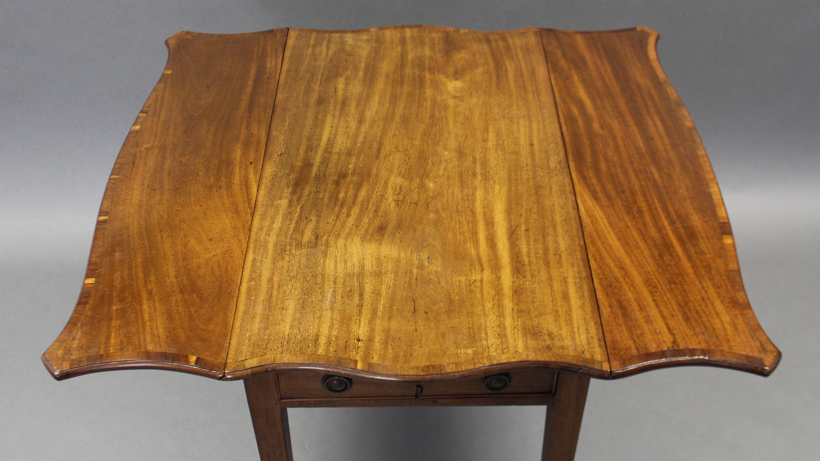 A George III mahogany Pembroke table of serpentine outline, the crossbanded top with canted corners, - Image 3 of 4