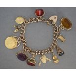 A 9ct. gold curb-link charm bracelet with padlock clasp & safety chain, a pendant George V sovereign