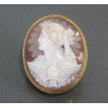 A carved shell oval cameo brooch depicting a classical female bust & a dove with wings spread, 1?” x
