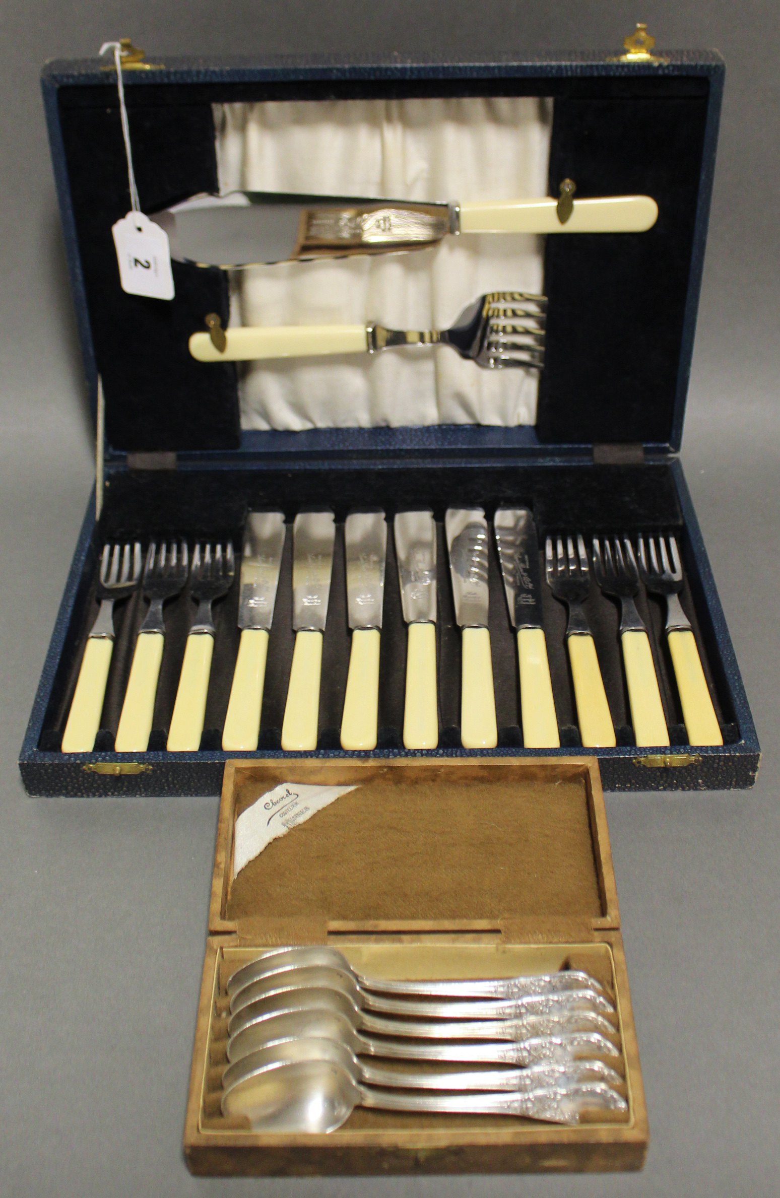 A stainless steel cutlery set, settings for six, with a pair of carvers in fitted case; & a set of