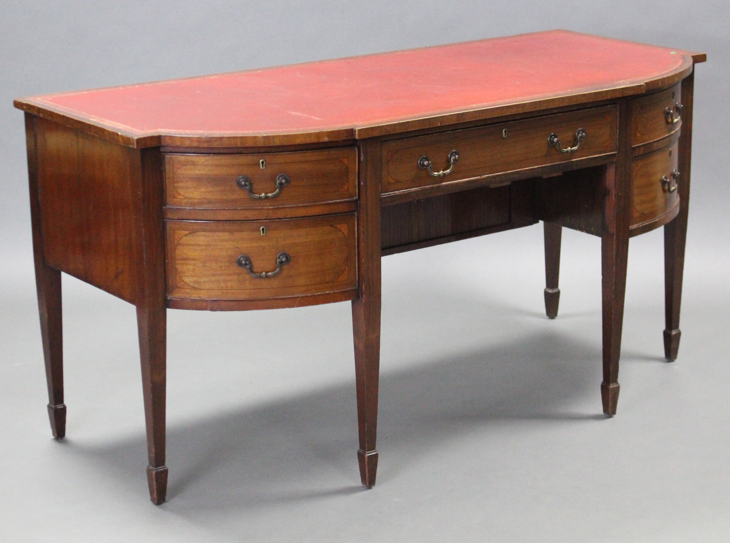 A 19th century mahogany bow-front sideboard, the shaped top inset crimson gilt-tooled leather