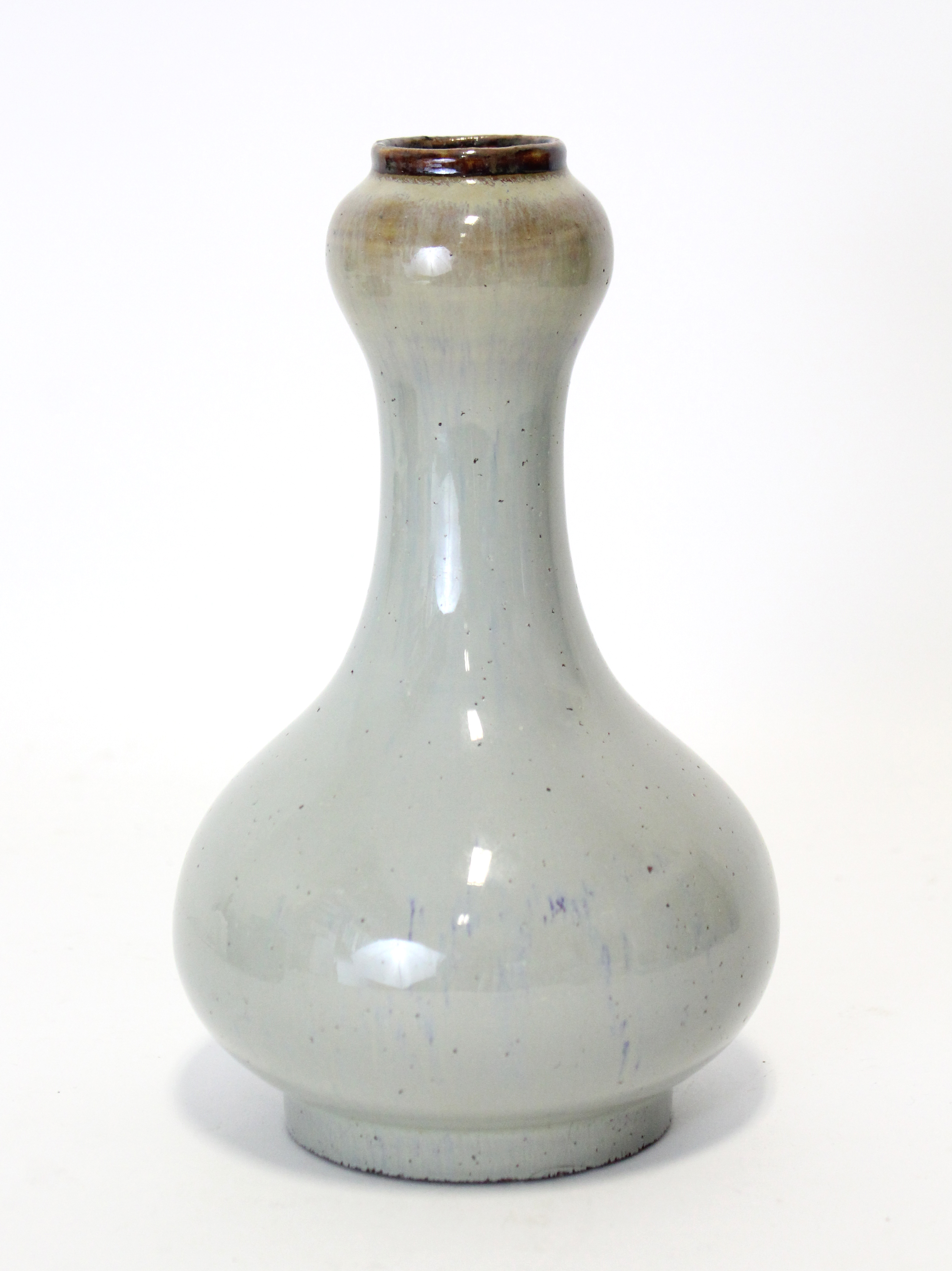 A CHINSE FLAMBÉ-GLAZED “GARLIC-MOUTH” VASE, the glaze of pale bluish tone, with pear-shaped body &