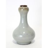 A CHINSE FLAMBÉ-GLAZED “GARLIC-MOUTH” VASE, the glaze of pale bluish tone, with pear-shaped body &