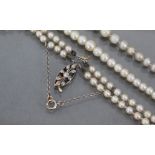 A double-row necklace of graduated cultured pearls, the pierced oval clasp set small diamonds (clasp