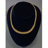 An antique gold Etruscan-style necklace designed as pairs of small circular links between fringes of