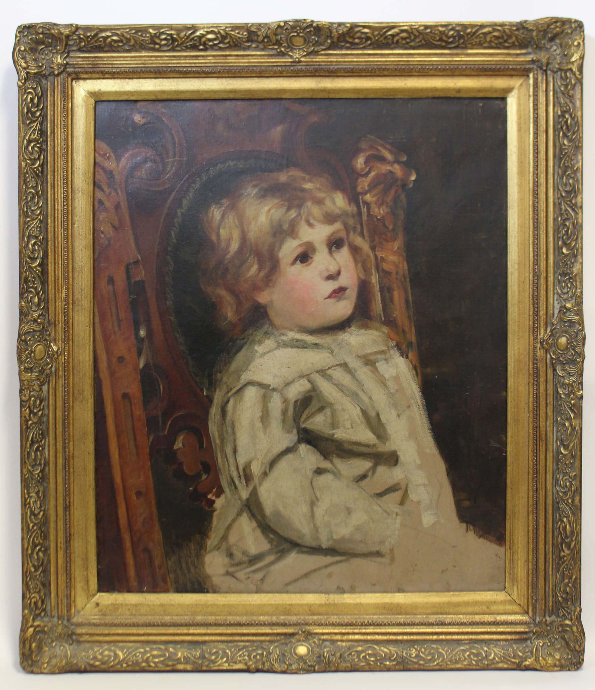 ENGLISH SCHOOL, late 19th century. A half-length portrait of a young child seated in a carved oak