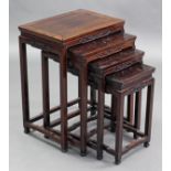 A nest of four Chinese hardwood rectangular occasional tables, each with carved archaic decoration