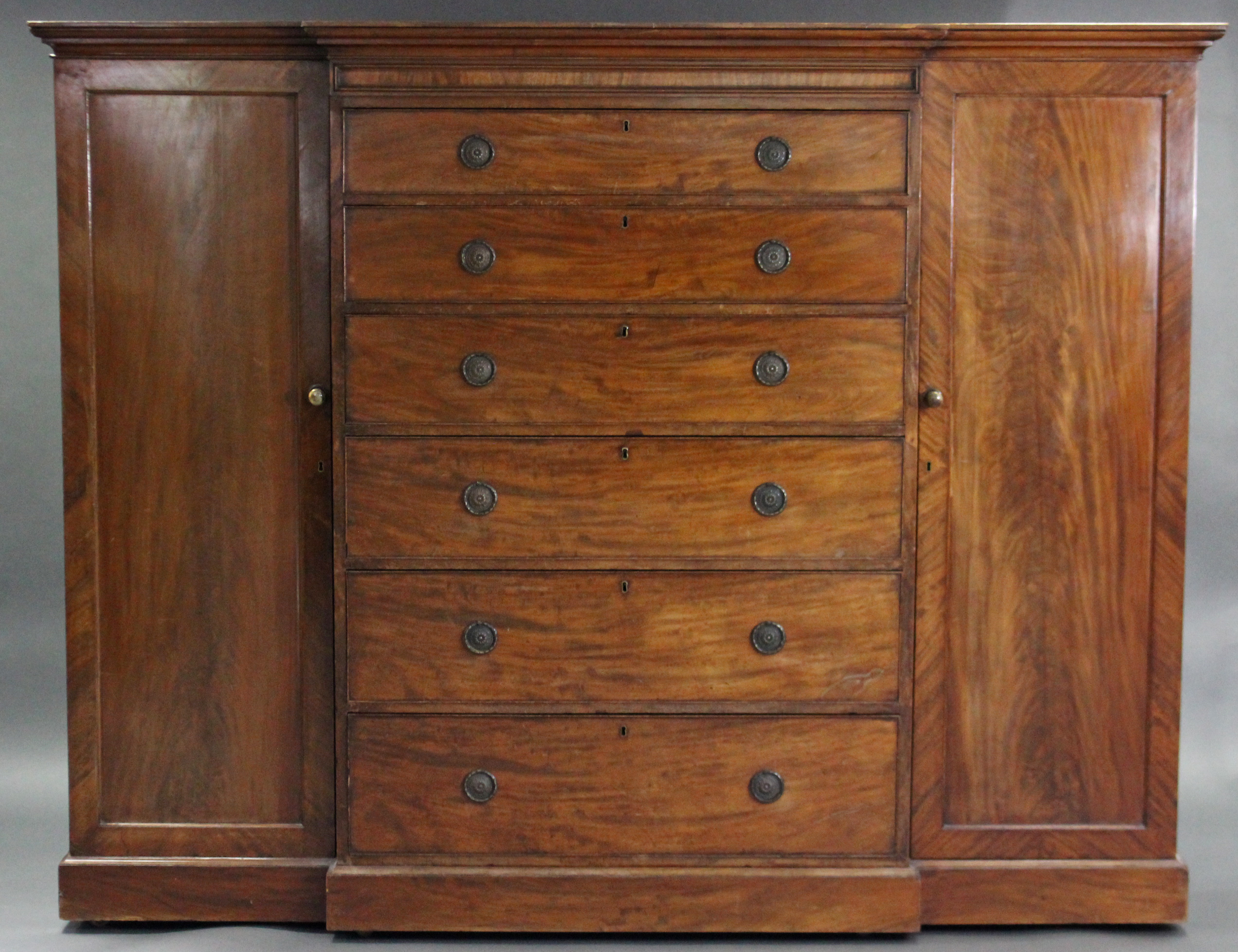 An early Victorian break-front three-section wardrobe, with moulded cornice, the central section