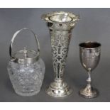 An Edwardian silver tall trumpet vase with all-over pierced scroll decoration, 7¾” high,