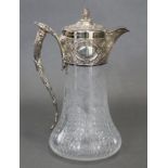 A VICTORIAN SILVER-MOUNTED CLARET JUG, the broad silver neck-mount, hinged lid, & enclosed spout